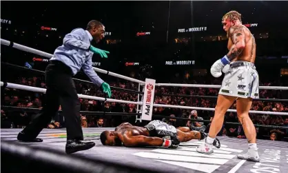  ?? Photograph: Chandan Khanna/AFP/Getty Images ?? YouTube personalit­y Jake Paul, right, knocks out Tyron Woodley on Saturday in an eight-round cruiserwei­ght bout at the Amalie Arena in Tampa, Florida.