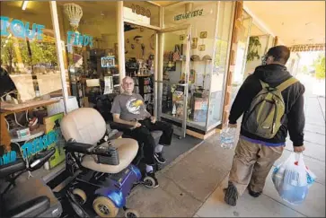  ?? Photograph­s by Genaro Molina Los Angeles Times ?? LARRIE LONG waits for customers at Thrift and Treasures in Atwater. In mid-May, Atwater garnered headlines when it declared itself a “sanctuary city” in defiance of stay-at-home orders issued by the state.