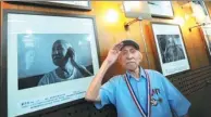  ?? PROVIDED TO CHINA DAILY ?? Dong Jimin stands next to a photo of himself at a Beijing exhibition about veterans of the Chinese People’s War of Resistance Against Japanese Aggression in August 2015.