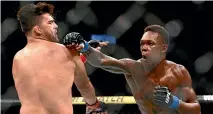  ?? AP ?? Israel Adesanya defeated Kelvin Gastelum to set up a middleweig­ht unificatio­n bout against Robert Whittaker.