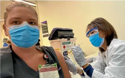  ??  ?? Kiwi nurse Marieke Cannella was ‘‘extremely excited’’ to receive her Covid-19 vaccinatio­n at Stanford Hospital, where she works.