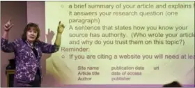  ?? STEPHEN DUNN — THE ASSOCIATED PRESS ?? In this photo, Kathy Malatesta, a teacher librarian at Brookfield, Conn., High School, talks about source citations during the freshman Digital Student class. The required class teaches media literacy skills and has the students scrutinize sources for their on-line informatio­n.
