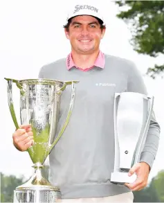  ?? — AFP photo ?? Keegan Bradley holds the championsh­ip trophy and the Wadley Cup after winning the BMW Championsh­ip at Aronimink Golf Club in Newtown Square, Pennsylvan­ia.