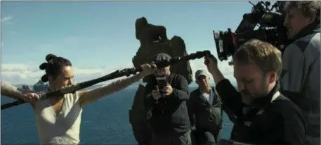  ?? All images courtesy Disney Lucasfilm ?? Star Wars: The Last Jedi Director Rian Johnson fine tunes a shot from a training montage involving Daisy Ridley’s ‘Rey’ next to the famous ‘Wailing Woman’ Rock on Skellig Michael.