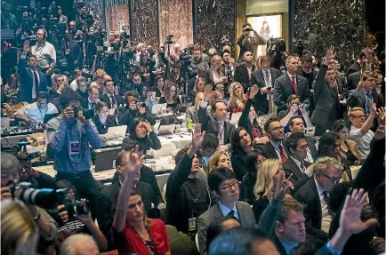  ?? PHOTO: WASHINGTON POST ?? Members of the media raise their hands to try and ask questions as President-elect Donald Trump speaks during a press conference at Trump Tower in New York yesterday.