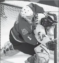  ?? JACQUES BOISSINOT, THE CANADIAN PRESS ?? Guelph Storm’s Ryan Callahan gets caught in the net as Rockets goalie Kelly Guard pushes him down during the second period of a Memorial Cup game in 2004 in Kelowna, B.C. Kelowna won, 1-0.