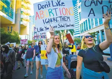  ?? NELVIN C. CEPEDA U-T ?? Demonstrat­ors march down Broadway past the Hall of Justice on Friday, where earlier they held a rally protesting the Supreme Court decision to overturn Roe v. Wade.