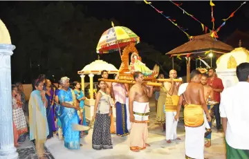  ??  ?? Devotees parade Goddess Durga around the temple as part of the activities to commemorat­e Navaratri and Thiruvila festivals.