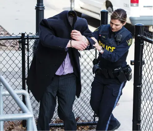  ?? ERROL MCGIHON / POSTMEDIA NEWS ?? Ryan Hartman is escorted by OPP officers to a holding cell at the Brockville courthouse Wednesday after being convicted of a 2011 sexual assault.