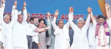  ?? Agence France-presse ?? ↑
Rahul Gandhi ( fourth left), Siddaramai­ah (centre) and DK Shivakumar (right) along with other leaders attend the swearing-in function in Bengaluru on Saturday.