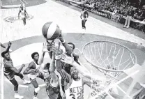  ?? RICHARD DREW/ASSOCIATED PRESS FILE PHOTO ?? The Denver Nuggets’ Bobby Jones, second left, the New York Nets’ Julius Erving, fourth left, and Jim Eakins, right, battle for a rebound during the ABA championsh­ip in May 1976 at the Nassau Coliseum in Uniondale, N.Y. The Nuggets are the last of the four ABA teams that merged with the NBA to reach the Finals and they are stirring up fond memories of the defunct league.