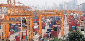  ?? BLOOMBERG ?? Containers are stacked at Klong Toey port in Bangkok. Precious Shipping expects a better year for the shipping industry, believing the global economic outlook is brighter after a disastrous 2014.