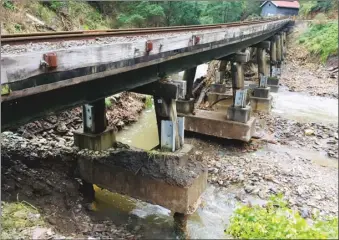  ?? Photo: WGR ?? Above: The extent of flood damage is obvious from the gouging out this bridge’s footings.