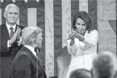  ?? DOUG MILLS AP ?? President Donald Trump turns to House speaker Nancy Pelosi of Calif., as he delivers his State of the Union address to a joint session of Congress on Capitol Hill in Washington, as Vice President Mike Pence watches on Tuesday. •