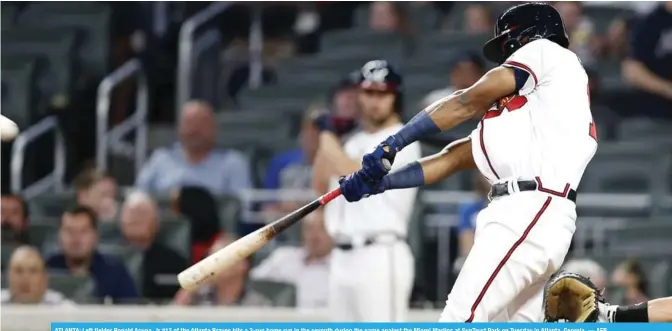  ??  ?? ATLANTA: Left fielder Ronald Acuna, Jr #13 of the Atlanta Braves hits a 3-run home run in the seventh during the game against the Miami Marlins at SunTrust Park on Tuesday in Atlanta, Georgia. — AFP