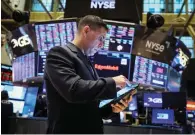  ?? — reuters ?? A trader at the New York Stock Exchange. The S&P 500 index is up over nine per cent for the year, up near its late-march record high.