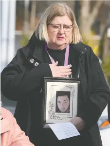  ?? DAN JANISSE ?? Kathy Moreland holds a photo of her son Austin, who died of a fentanyl overdose in 2020 at the age of 18. She was participat­ing in a vigil on March 28 in downtown Windsor.