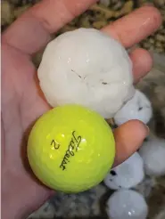  ?? (Randy Smith via AP) ?? In this image provided by Randy Smith, a large chunk of hail is compared to the size of a golf ball on Wednesday night in Shawnee, Kan.