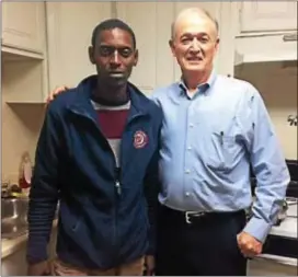  ?? LOIS PUGLIONESI — DIGITAL FIRST MEDIA ?? Sudanese refugee Osman Ali poses for a photo with the Rev. Poorman, parish associate at Ardmore Presbyteri­an Church. Sturgis