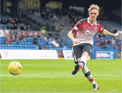  ?? Picture: SNS. ?? Kevin McHattie scores what proves to be the winning penalty in the shoot-out.