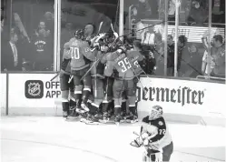  ?? Nick Wass/Associated Press ?? ■ Washington Capitals celebrate after Game 5 of an NHL first-round hockey playoff series as Columbus Blue Jackets goaltender Sergei Bobrovsky (72), of Russia, skates by on Saturday in Washington. The Capitals won, 4-3, in overtime.