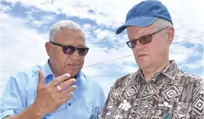  ??  ?? Prime Minister Voreqe Bainimaram­a (left), with director for Strategy at the United Nations Framework Convention on Climate Change (UNFCCC) Secretaria­t Halldór Thorgeirss­on yesterday in Kumi Village, Verata, Tailevu.