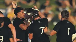  ?? Albert Perez/Getty Images ?? The New Zealanders celebrate a try in the first half of their under-20 Rugby Championsh­ip finale against Australia.