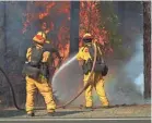  ?? KELLY JORDAN/USA TODAY NETWORK ?? Crews battle the flames near the Trinity County line in Northern California as the fire toll mounted.