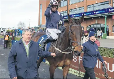  ?? (Pic: INPHO/Morgan Treacy) ?? WALK OF A CHAMPION - Jockey Patrick Mullins after winning The Tattersall­s Ireland George Mernagh Memorial Sales Bumper on board Kopek Des Bordes, being led in by Fermoy’s Charlie McCarthy and a stable hand, on day 2 of the Fairyhouse Easter Festival.