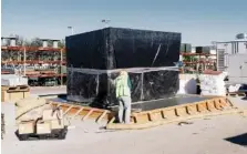  ?? COLEY BROWN/THE NEW YORK TIMES ?? In 2016, a grid-sized battery energy storage facility in Escondido, Calif., is shown. The batteries deliver solar power after dark in California and help to stabilize grids in other states.