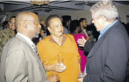  ?? ?? Jamaica Observer columnists Barbara Gloudon and Clyde Mckenzie (left) in discussion with the newspaper’s founder Gordon “Butch” Stewart (now deceased) at a function in 2003 marking the Observer’s 10th anniversar­y.