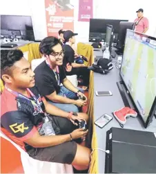  ?? — Bernama photo ?? File photo shows gamers play the FIFA game during an esports exhibition.