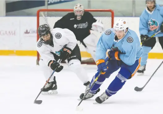  ?? PRESTON EMERSON/GO TIME PHOTOGRAPH­Y INC. ?? Regina top prospect Connor Bedard, in white, defends against NHL star Mathew Barzal during a 2019 charity tournament in Vancouver.