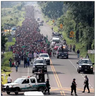  ?? AP/MOISES CASTILLO ?? Central American migrants leave Ciudad Hidalgo, Mexico, on Sunday and continue their walk to the United States. Despite efforts by Mexican officials to stop them, about 5,000 migrants headed for the U.S. border.