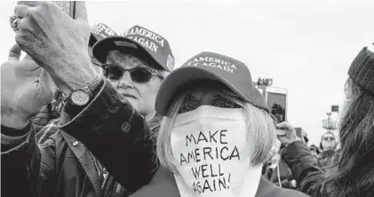  ?? ANNA MONEYMAKER/THE NEW YORK TIMES ?? A supporter of President Donald Trump wears a mask at a campaign rally in Reading, Pennsylvan­ia on Oct. 31.