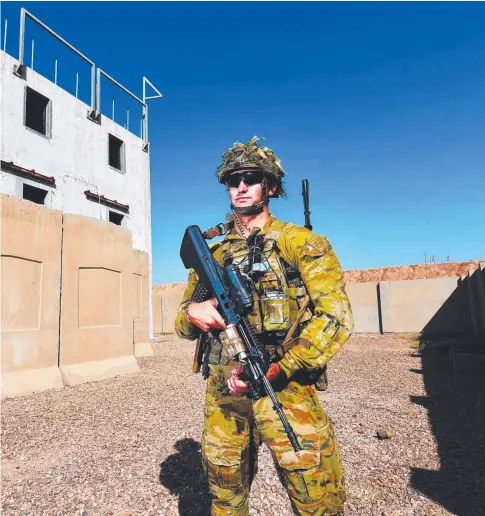  ?? VITAL JOB: Inside the Amber Zone of Taji Military Complex, Lieutenant Mitch King from Task Group Taji- 5 Quick Reaction Force walks around one of the urban training areas. Pictures: ZAK SIMMONDS ??