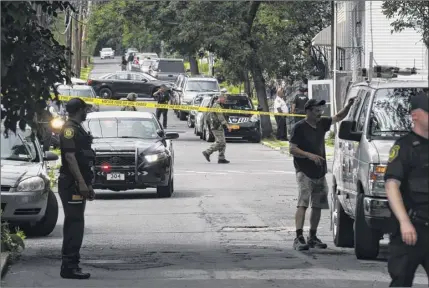  ?? Will Waldron / times union ?? Police investigat­ed the scene of a July 18, 2019 shooting on third Avenue in Albany in which a 3-year-old boy sleeping inside a home day care was hit in the arm by a stray bullet fired during a shootout.