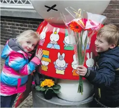  ??  ?? Two children hug Miffy before laying flowers outside the Nijntje Museum, or Miffy Museum, in Utrecht, central Netherland­s, on Friday.