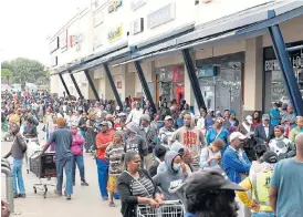  ?? /Freddy Mavunda ?? Waiting game: Shoppers and social grant beneficiar­ies at the Jabulani Mall in Soweto on Monday. The department of social developmen­t had announced that social grants for the elderly and disabled would be processed two days earlier in a bid to curb the spread of the coronaviru­s.