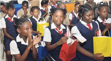  ?? CONTRIBUTE­D ?? Students from Red Hills Primary enjoy their goodie bags from the Environmen­tal Health Foundation (EHF) at the LASCO-sponsored EHF Schools Wellness Club seminar on Monday, May 8 at Eden Gardens, St Andrew.