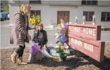  ?? Peter DaSilva / Special to The Chronicle ?? Veterans Home of California resident Lynn Ford leaves flowers at a memorial with Lori Cagwin of Yountville (left).