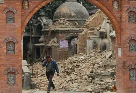  ?? NIRANJAN SHRESTHA/AP ?? A Nepalese man cries as he walks through the earthquake debris in Bhaktapur, near Kathmandu, Nepal.