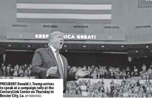  ?? Ap/ eVan VuCCi ?? PReSIDeNT Donald J. Trump arrives to speak at a campaign rally at the CenturyLin­k Center on Thursday in Bossier City, La.