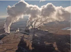  ?? DON J. USNER/SEARCHLIGH­T NEW MEXICO ?? Smoke billows from the San Juan Generating Station. The plant, built in the 1970s, is scheduled to close in 2022 as utilities and the state transition from coal to cleaner power sources.