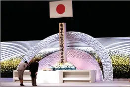  ?? BEHROUZ MEHRI — POOL PHOTO ?? Japan’s Emperor Naruhito, right, and Empress Masako bow in front of the altar for victims of the earthquake and tsunami at the national memorial service in Tokyo on Thursday.