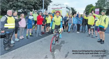  ?? PICTURE BY CHARLIE BRADY ?? Jimmy Currid backed by a hearty crew on his charity cycle and climb.