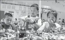  ?? YUAN CHEN / FOR CHINA DAILY ?? Children play with Lego blocks during the China Internatio­nal Consumer Products Expo in Haikou, Hainan province, on Thursday.