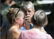  ?? DAVID JOLES — STAR TRIBUNE VIA AP ?? Former Minnehaha Academy employees Elizabeth Van Pilsum, left, and Rick Olson, center, react after an explosion at the school Wednesday in Minneapoli­s.