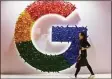  ?? Associated Press file photo ?? A woman walks past the logo for Google in Shanghai in 2018.