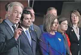  ?? Mark Wilson Getty Images ?? HOUSE DEMOCRATS discuss the trade pact. The day’s conf licting images bolstered Democrats’ claim that they didn’t come to Washington just to fight Trump.